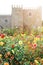 The Garden of Santa Barbara alongside the eastern wing of the historical Archbishop`s Palace. Colorful flowers under the bright su
