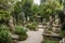 a garden with sculptures and plants, creating a peaceful and serene atmosphere