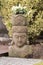 Garden Statue, Balinese Divinity with Christmas Rose Plants on Head in Winter