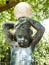 garden statue.  child figure with lamp globe on his head.  dirty with cobwebs.