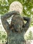 garden statue.  child figure with lamp globe on his head.  dirty with cobwebs.