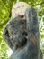 garden statue.  child figure with lamp globe on his head.  dirty with cobwebs.