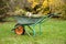 Garden steel robust wheelbarrow with garden garbage. Concept preparing garden for winter season