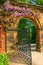 Garden Stone Arched Gateway Surrounded by Flowers