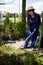 A garden store worker prepares the soil for new seedlings.