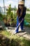 A garden store worker prepares the soil for new seedlings.