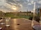 Garden during summer sunset, sprinkling water on perfect green lawn, grass, bowling green