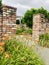 The garden is surrounded by brick walls and The tiger lilies