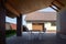 Garden table, chairs stand under a canopy in the shade. Hot sunny day