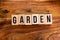 ` GARDEN ` text made of wooden cube on  wooden background