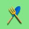 Garden tool. Blue blade and a yellow fork on green background
