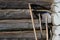 Garden tool - scythe, shovel, rake. Wall of the rural house made from wooden logs