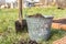 Garden tools, a bucket of earth and a shovel. Seasonal work in the garden at the cottage