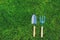 garden tools on green lawn background. Seasonal spring or summer yard work concept