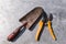 Garden tools. Red dirty shovel and yellow pruner