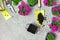 Garden tools, soil and pink flowers on a stone table