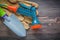 Garden water pistol safety gloves hand spade on wooden board gar