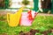 Garden watering cans and gloves on a lawn