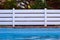 Garden white wooden fence near swimming pool side relaxation space on back yard background picture