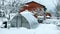 garden in winter, greenhouse covered with snow, trees, garden house and garden accessories