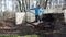Garden worker with pitchfork dig compost humus to barrow. 4K
