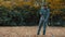 Garden worker raking dry leaves in the garden with a rake