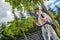 Garden Worker Spraying Backyard Trees and Plants
