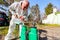 Gardener is blending substance with water in proper scale for sprinkles fruit trees