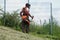 Gardener with Brush cutter in a Sloping slope