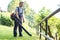 Gardener clearing up the leaves using a leaf blower