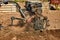 Gardener cultivate ground soil with tiller tractor or rototiller, cutivator