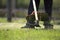 The gardener cutting grass by lawn mower