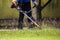 The gardener cutting grass by lawn mower