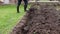 Gardener digs a flower bed with a spade and prepares a groove for manure. Soaking the clay. Country life. Video shot Full HD 60 fp