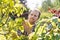 Gardener examining leaves on branch at garden