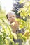 Gardener examining plants at garden