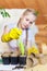 A gardener girl pours seedling soil into peat pots. Gardening, spring planting.