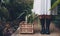 Gardener in greenhouse with plants in basket on floor