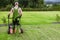 Gardener in His 40s and His Powerful Gasoline Lawn Aerator