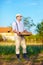 Gardener holding box with potatoes, countryside