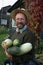 Gardener holding large marrows