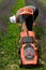 A gardener inspects a lawnmower before mowing the grass