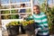 Gardener loading buckets with picked tomatoes in truck