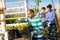 Gardener loading buckets with picked tomatoes in truck