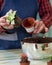 Gardener making, planting terrariums with succulents