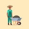 Gardener man pushing wheelbarrow full of earth compost african american male farmer working in garden wearing overalls