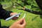 Gardener with notebook and pen in his hands inspections live cut