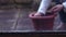 Gardener planting bulbs in a plant pot through view of window