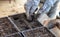 Gardener prepares soil for seedlings in spring