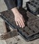 Gardener prepares soil for seedlings in spring